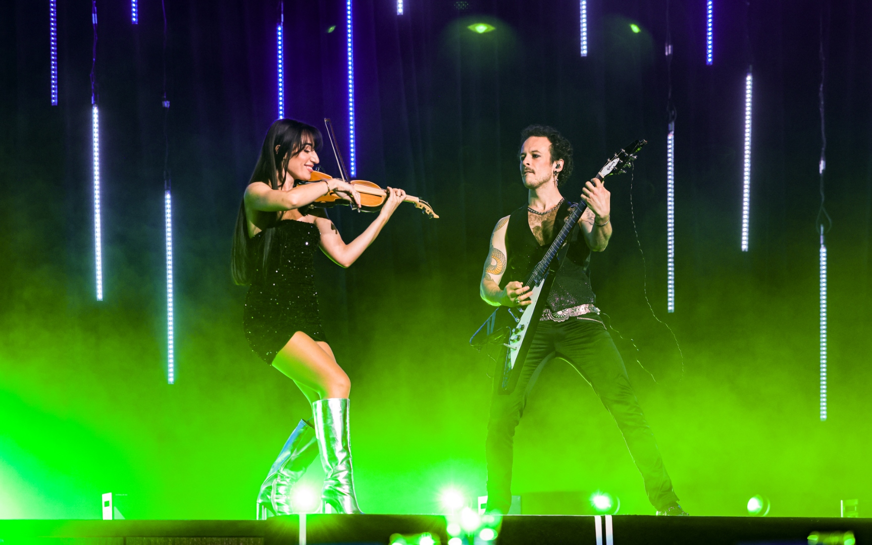 Guitar and violin performing together on stage